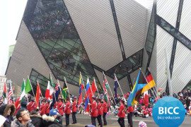 A parade of students carrying different flags