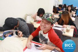 a boy with a smartphone in his hand is smiling