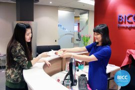 a girl offering a cake piece to a receptionist