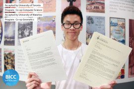 a boy student showing two documents