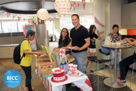 a man and two girls at the food table