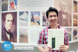 a boy is smiling with a certificate in his hands