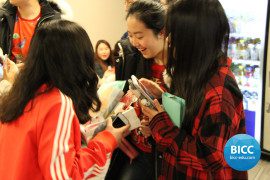 Three girl students looking at the gifts