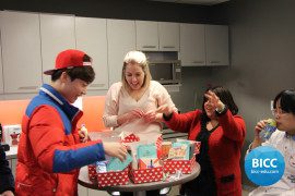 two women and a boy looking at the gifts